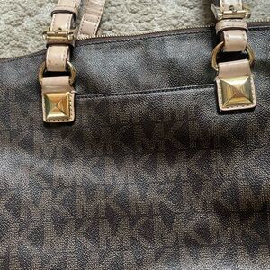 Michael Kors purse brown with signature print.